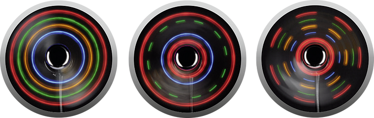 Drei Fahrradreifen mit bunten LED-Lichteffekten in verschiedenen Mustern bei Drehung